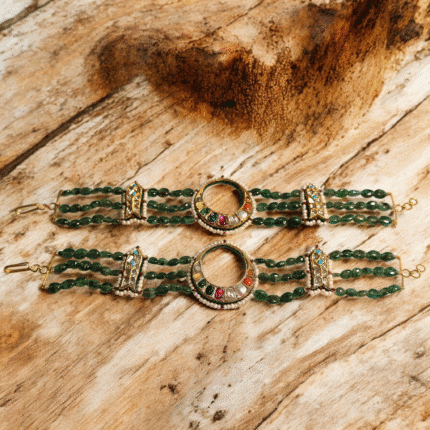 Women’s gold bracelet studded with gemstones and diamonds