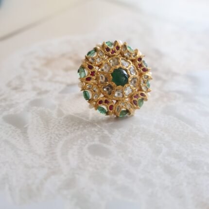 22kt gold ring studded with emeralds and diamonds, handcrafted with elegant traditional detailing.