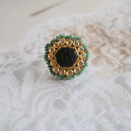 22kt gold ring with carved emeralds and diamond polkies, handcrafted with traditional detailing and vintage finish.