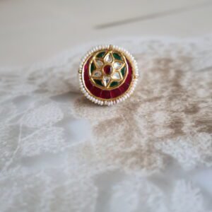 Rakhri with Kundan stones and freshwater pearls, handcrafted in traditional design with floral detailing.