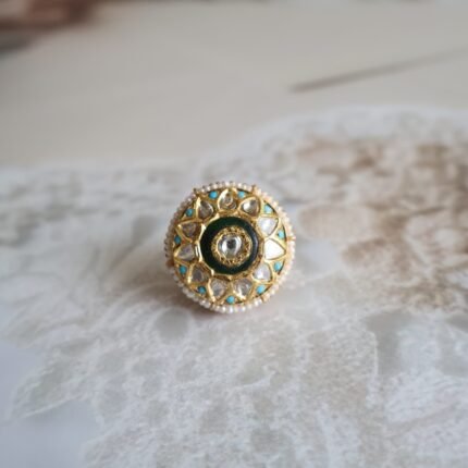 Rakhri with firoza stones, diamond polkies, and freshwater pearls, handcrafted in traditional design for festive and bridal wear.