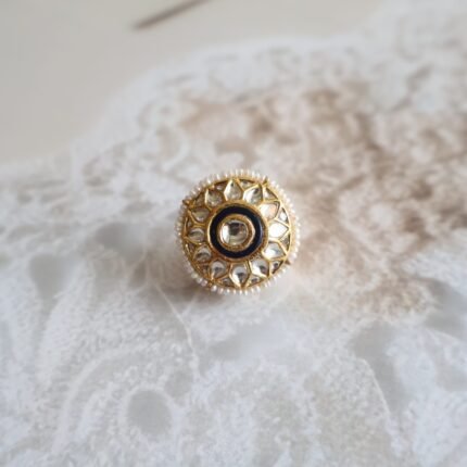 Rakhri with Kundan stones and freshwater pearls, handcrafted in traditional floral design for bridal and festive wear.