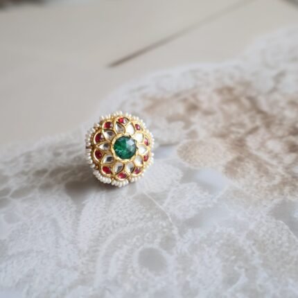 Rakhri with Kundan stones, freshwater pearls, and back enamelling, handcrafted in a traditional floral design.