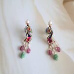 22kt gold earrings with peacock motifs and freshwater pearls, handcrafted traditional Indian design.